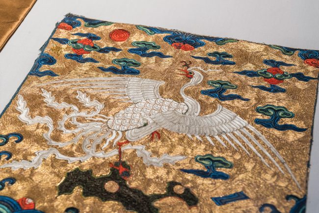 Fifth Rank Civil Badge (Silver Pheasant) , China, Kangxi Period (1680-1700), Embroidered polychrome silk, gold threads, peacock feather filaments Photo City University of Hong Kong