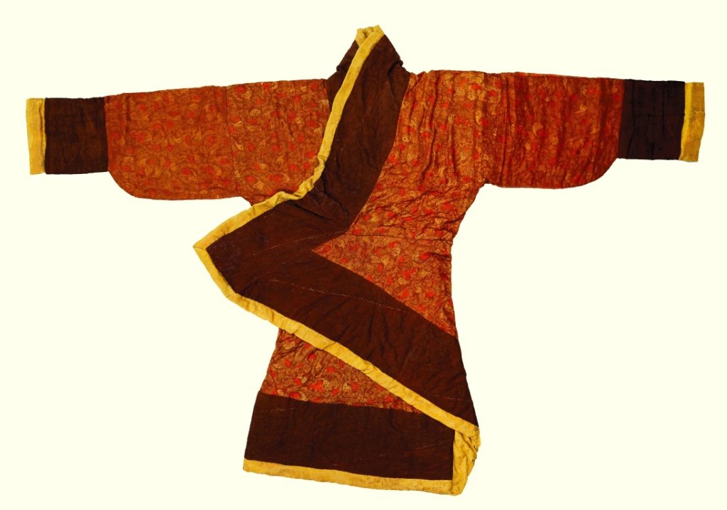  Silk-padded robe with Chang Shou (longevity) embroidery on a crimson-purple juan (plain weave silk) ground Western Han dynasty (202 BCE - 8), Collection of Hunan Museum, Photo credit Antiquities and Monuments Office Development Bureau, Han dynasty