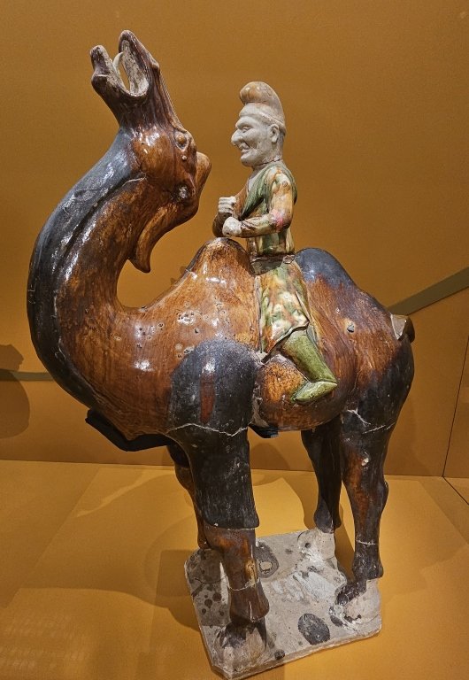 Sancai (tri-colour) glazed Hu figurine of a camel rider, Tang dynasty, Sui Tang dynasty