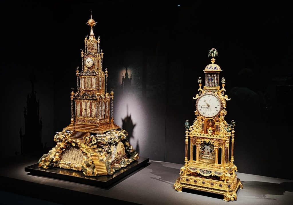 Left: Musical table clock, James Cox (active in 1749-1791), Great Britain, 18th century, Gilded and patinated bronze, agate, glass, and textile, Right: Musical clock, Qing dynasty (1644-1911), Gilt bronze, enamel, and glass, The Palace Museum, Forbidden City and the World