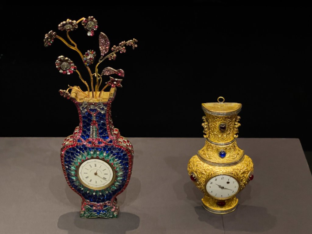 (left) Gilt bronze wall clock with coloured glass inlay, ca.18th century, Metal (gilt bronze) and glass (right) Gilt bronze wall clock with design of lotus scrolls, Qianlong period (1736-1795), Qing dynasty, Metal (gilt bronze) and glass, Proudly from Canton, Cantonese and Export Art, HKMoA